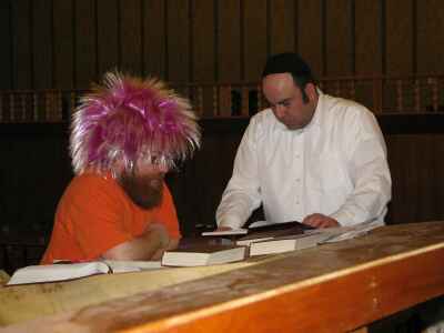 Rabbi Galperin and Aaron Kagan reading from the Megillah